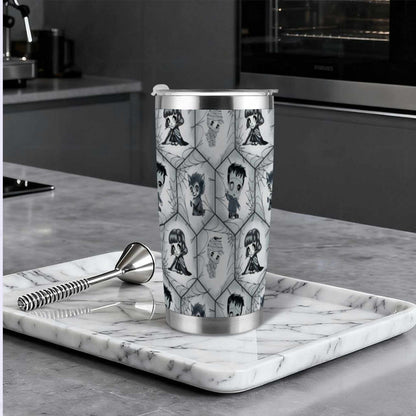 Grayscale monster tumbler on a marble tray in a modern dark kitchen beside a cocktail muddler