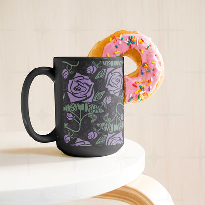 15 oz anti-Trump black ceramic mug with lavender floral print displayed on white cake stand with sprinkle donut