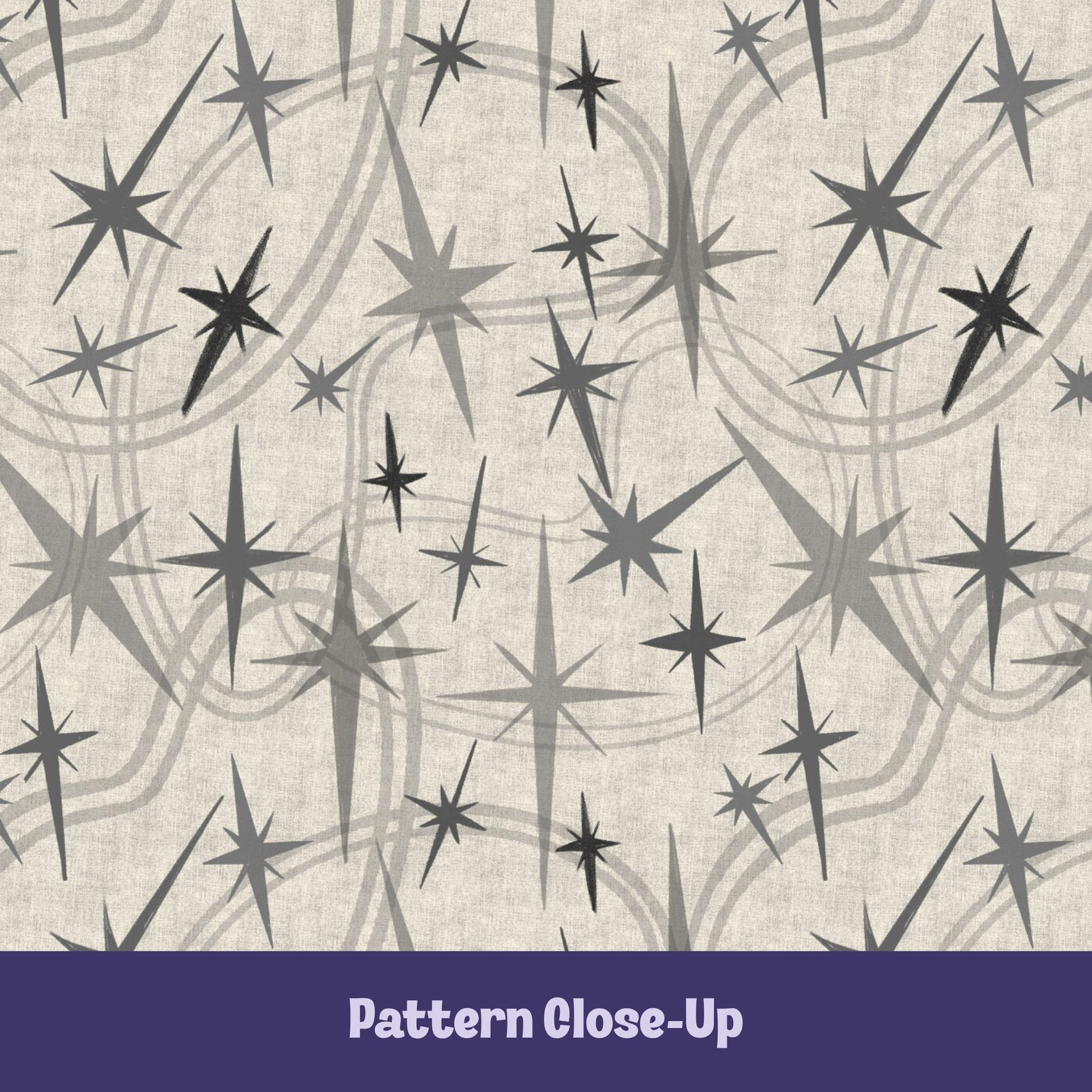Close-up of the warm gray and charcoal atomic starburst pattern on a natural oatmeal background showing varied starburst sizes and layered concentric swoosh details