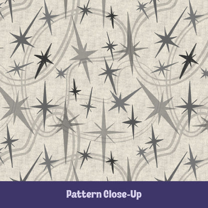 Close-up of the warm gray and charcoal atomic starburst pattern on a natural oatmeal background showing varied starburst sizes and layered concentric swoosh details
