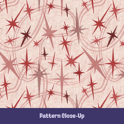 Close-up of the dusty rose and crimson atomic starburst pattern on a blush background, showing freehand-illustrated starburst motifs in varied sizes with concentric orbit curve details