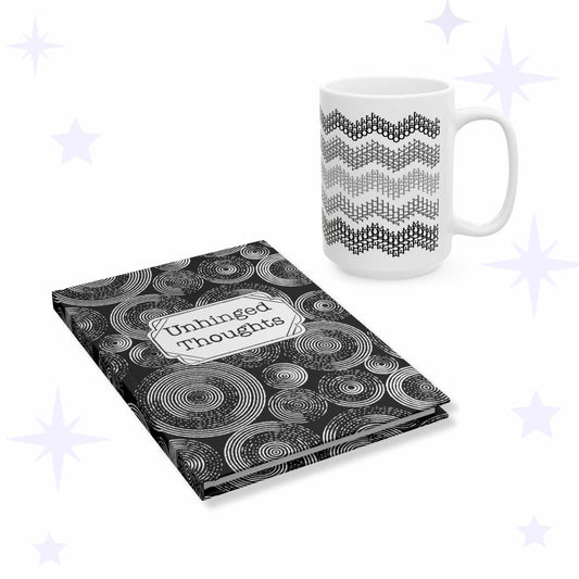 White ceramic mug with five gray chevron stripes beside a black hardcover journal covered in white concentric circles with an Unhinged Thoughts label plaque.