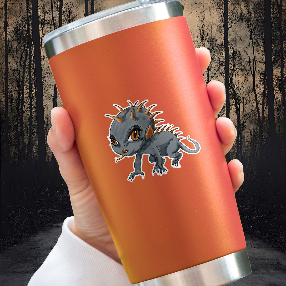 Chupacabra sticker with orange spines and amber eyes applied to an orange insulated tumbler