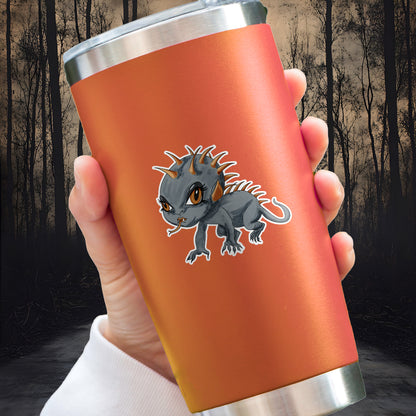 Chupacabra sticker with orange spines and amber eyes applied to an orange insulated tumbler