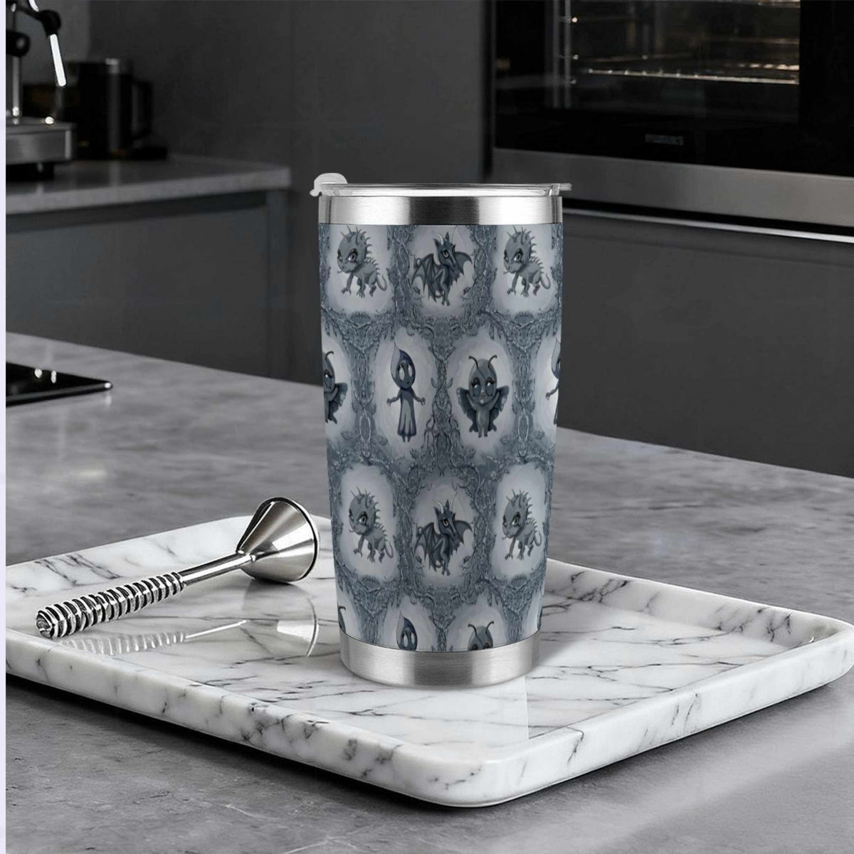 Cryptid tumbler on a marble tray in a modern dark kitchen beside a cocktail muddler