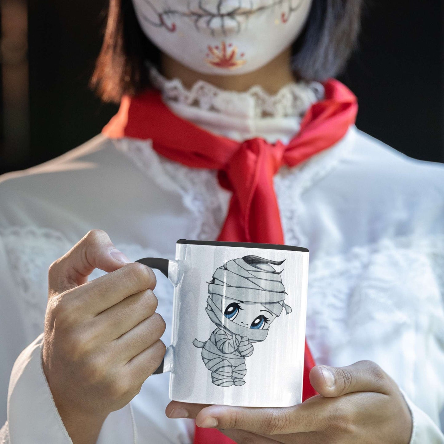 Person in Halloween costume holding the cute mummy coffee mug with a chibi bandaged character