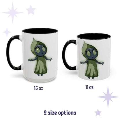 Chibi Flatwoods Monster cryptid mug shown in 15 oz and 11 oz, white ceramic with black interior and handle