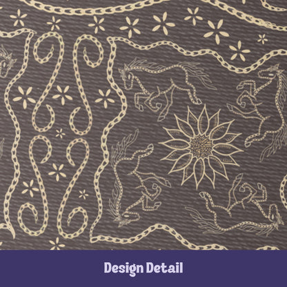 Close-up detail of vintage equestrian embroidered design showing galloping horses, sunburst medallion, and scrolling chain flourishes in cream on dark brown