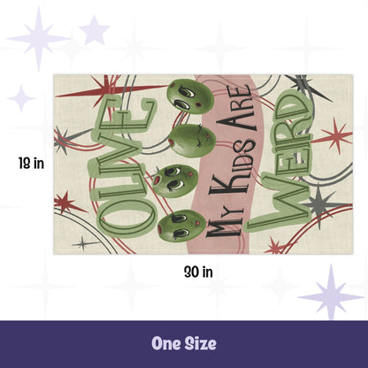 Retro kitchen tea towel flat lay showing 18 by 30 inch dimensions, olive pun illustration with cartoon olive faces and mid-century atomic starbursts on cream cotton twill