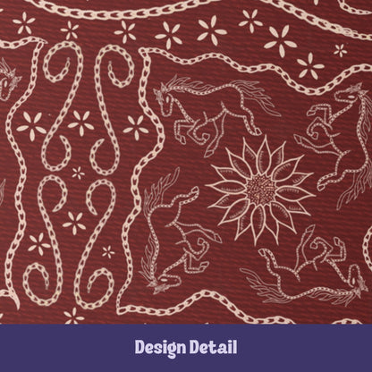 Close-up detail of stitched leather effect folk art illustration showing galloping horses, sunflower medallion, and chain-stitch rope scrollwork on burgundy journal cover