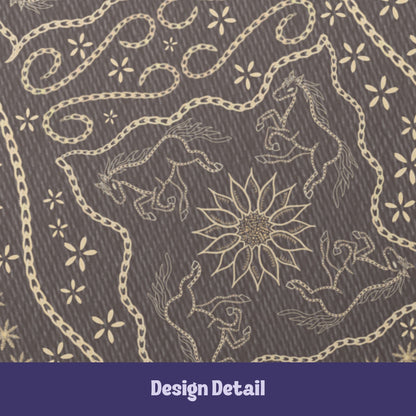 Design detail showing two hand-drawn galloping horses flanking a sunburst medallion with chain-stitch scrollwork on taupe softcover journal