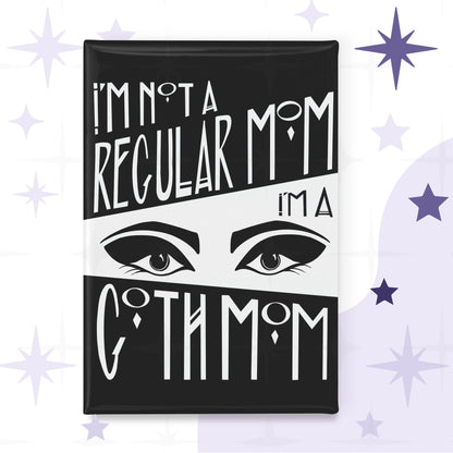 Rectangular fridge magnet with bold black-and-white Art Deco hand lettering reading I'm Not a Regular Mom / I'm a / Goth Mom, split by a dramatic pair of lined eyes on white background
