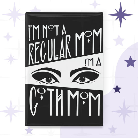 Rectangular fridge magnet with bold black-and-white Art Deco hand lettering reading I'm Not a Regular Mom / I'm a / Goth Mom, split by a dramatic pair of lined eyes on white background