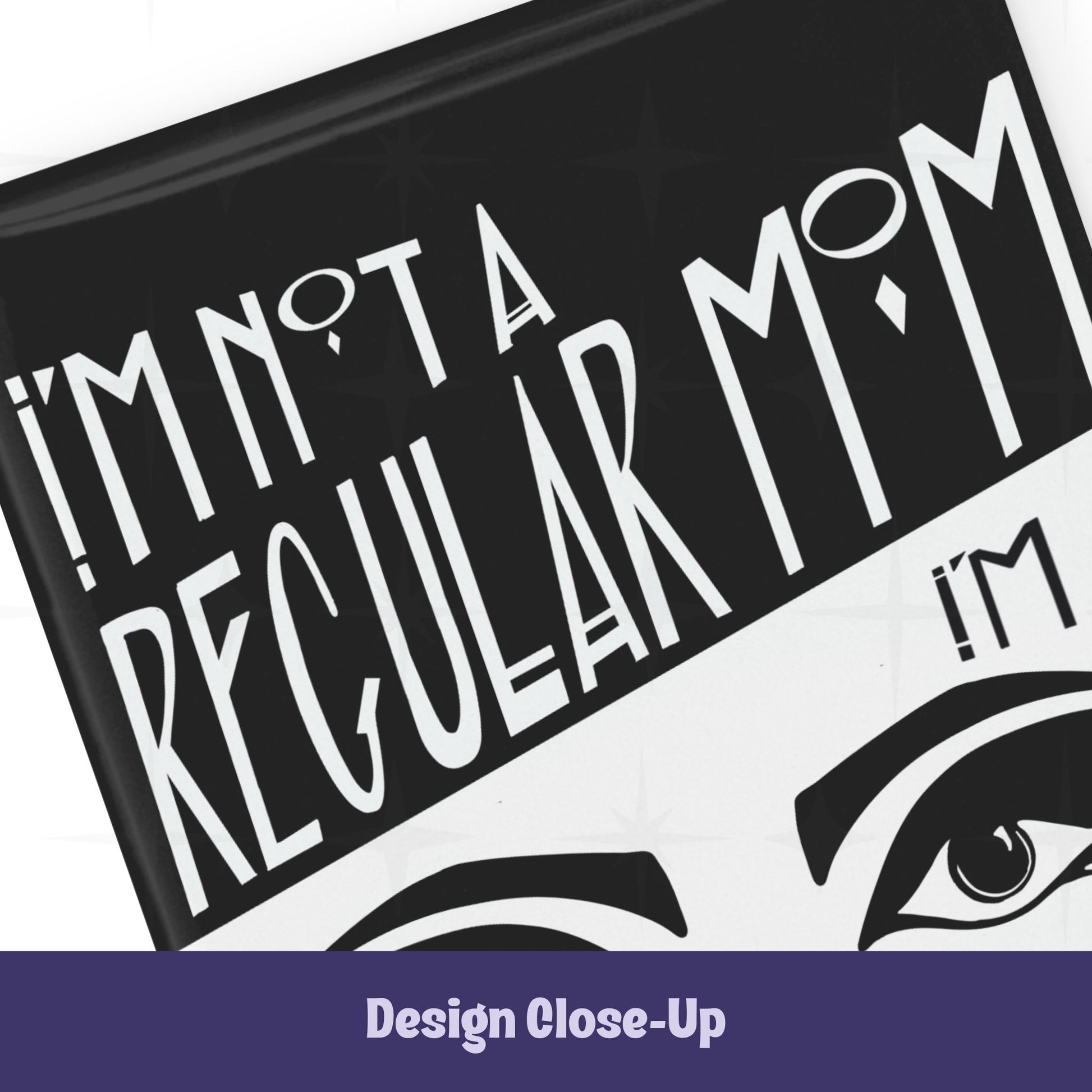 Close-up of top section of goth mom magnet showing Art Deco hand-lettered text I'm Not a Regular Mom on black with bold graphic eyebrow detail below