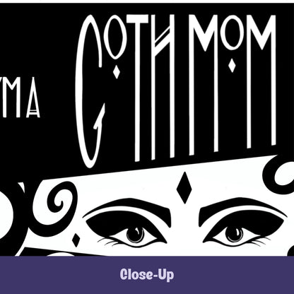 Close-up of gothic coffee mug showing Goth Mom lettering above hand-drawn masquerade-style eyes with winged liner and diamond gem on white band on black ceramic