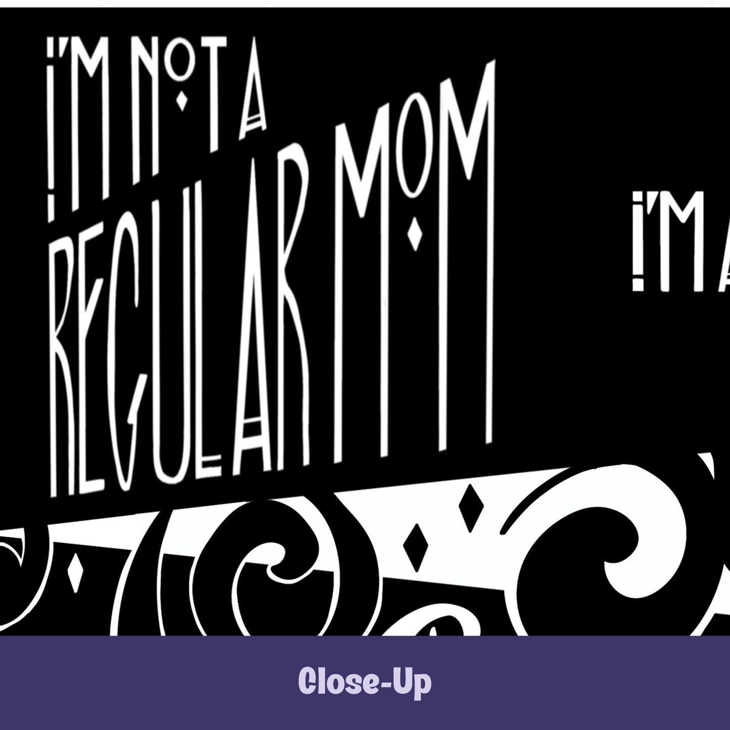 Close-up of goth mom mug showing hand-lettered I'm Not a Regular Mom in tall gothic Art Deco type with diamond accents and baroque scroll illustration on black ceramic