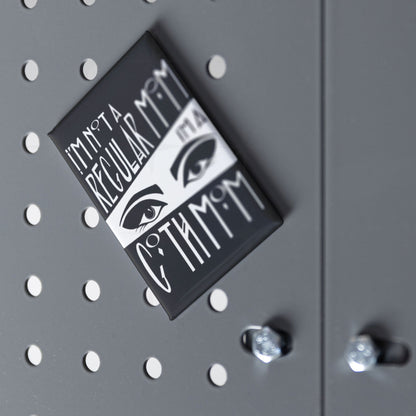 Goth mom fridge magnet displayed at an angle on a grey pegboard surface with chrome hardware visible