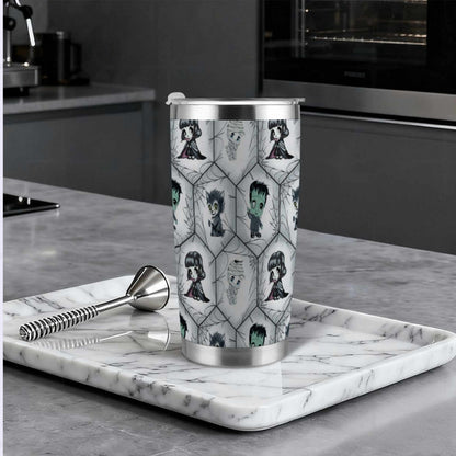 Chibi monster goth tumbler on a marble tray in a modern dark kitchen beside a cocktail muddler