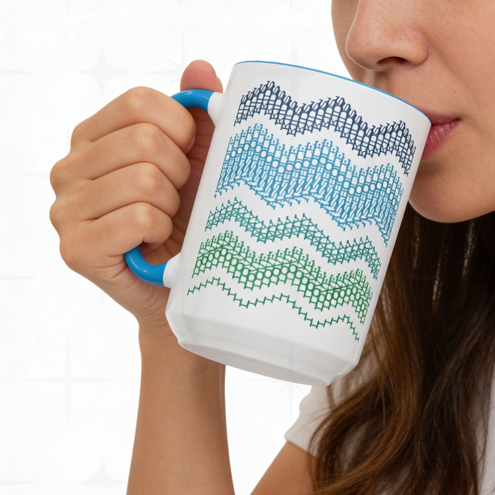 Woman drinking from Ocean & Blue hidden message mug 15oz against white tile — close-up showing the navy, blue, teal, and green typographic chevron wave pattern