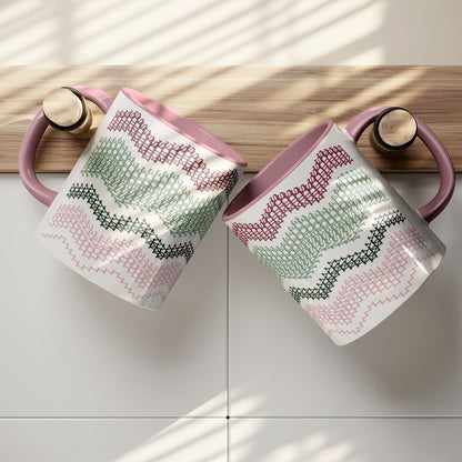 Two Preppy & Pink hidden message mugs resting on a wooden kitchen shelf ledge against white tile — overhead lifestyle shot showing both sides of the typographic pattern