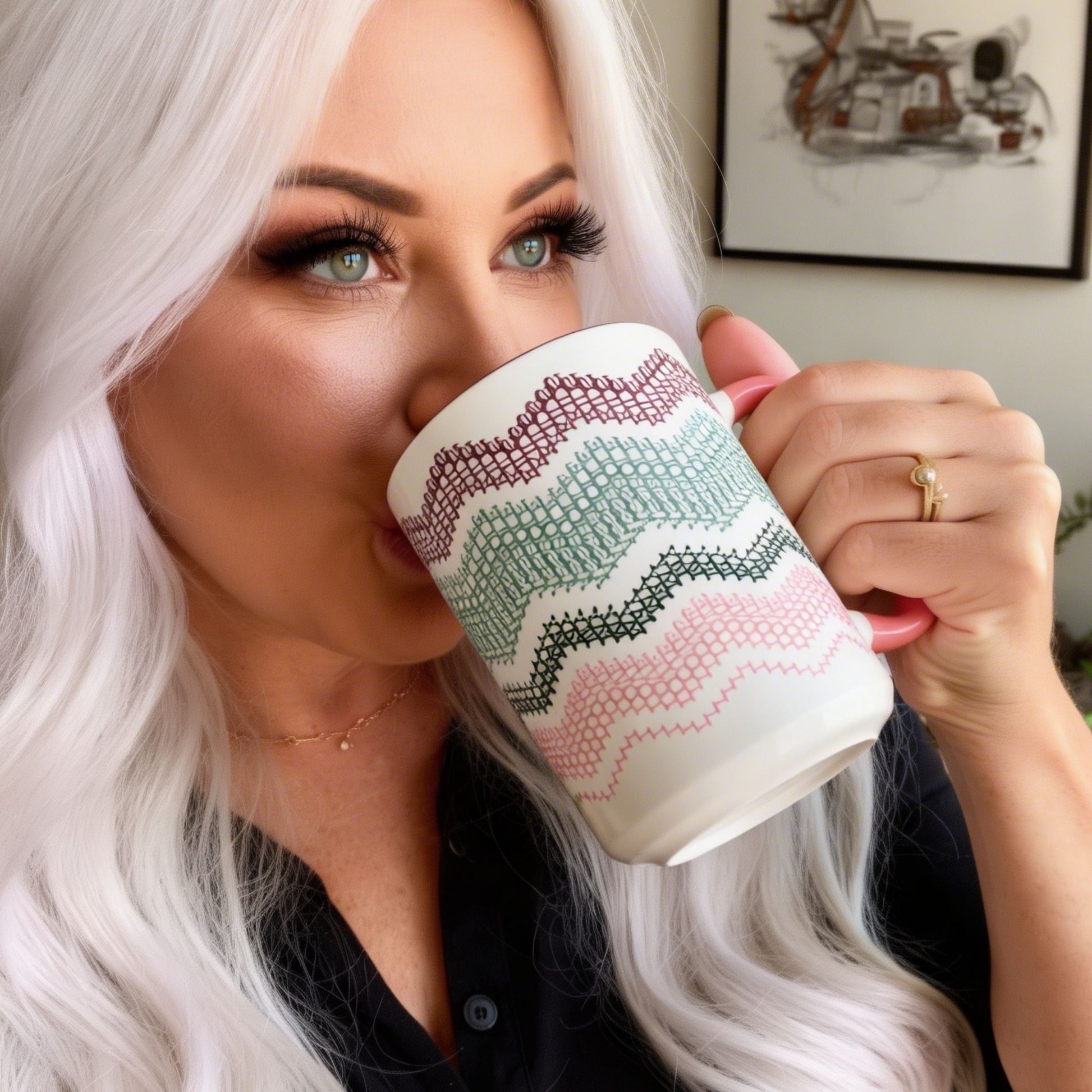 White-haired woman drinking from Preppy & Pink hidden message mug — close portrait showing the burgundy, green, and pink fair isle typography pattern on the ceramic