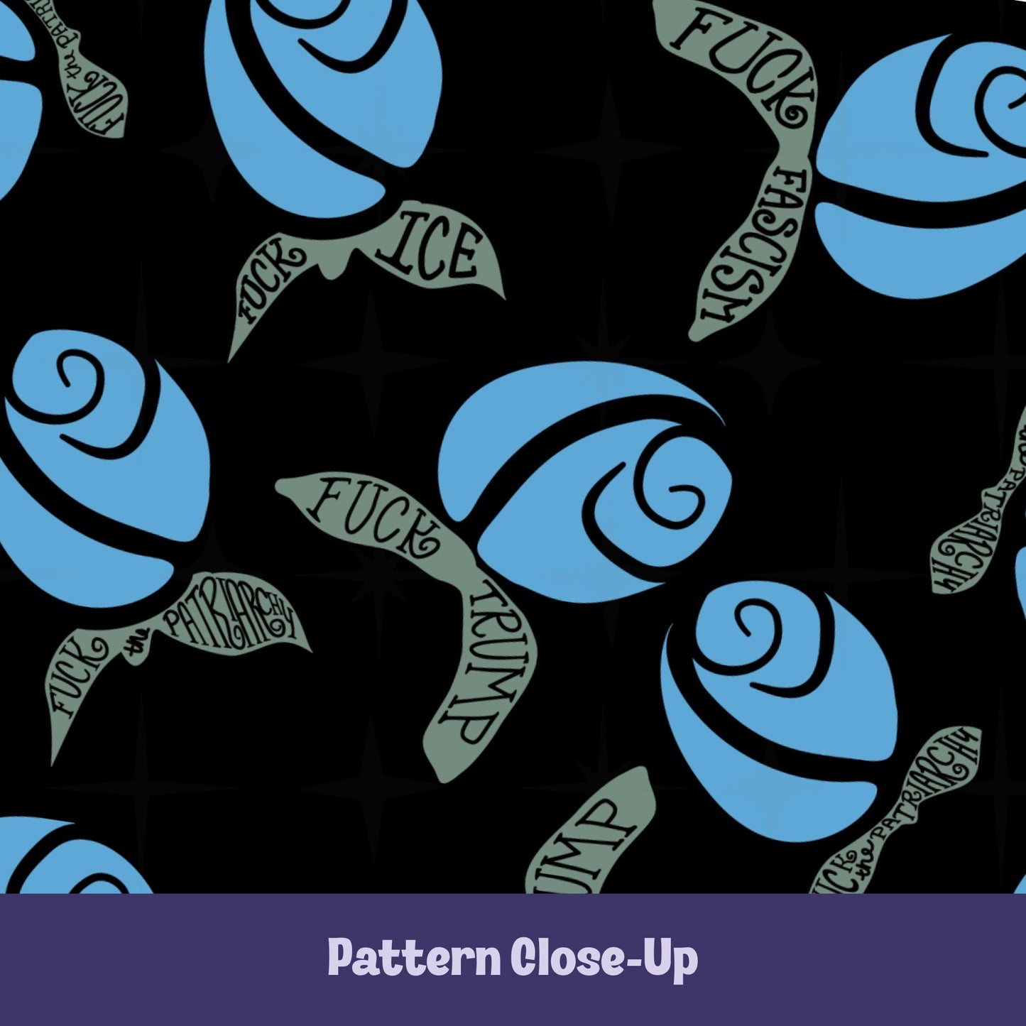 Close-up of blue hidden message mug — cornflower blue rosebuds with sage green hand-lettered leaves reading Fuck Fascism, Fuck Trump, Fuck the Patriarchy, and Fuck ICE