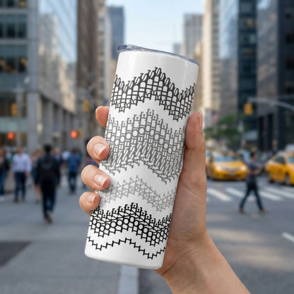 20 oz hidden message skinny tumbler held in an urban setting, gray stripes colorway — four horizontal chevron wave bands in black, charcoal, gray, and light gray on white