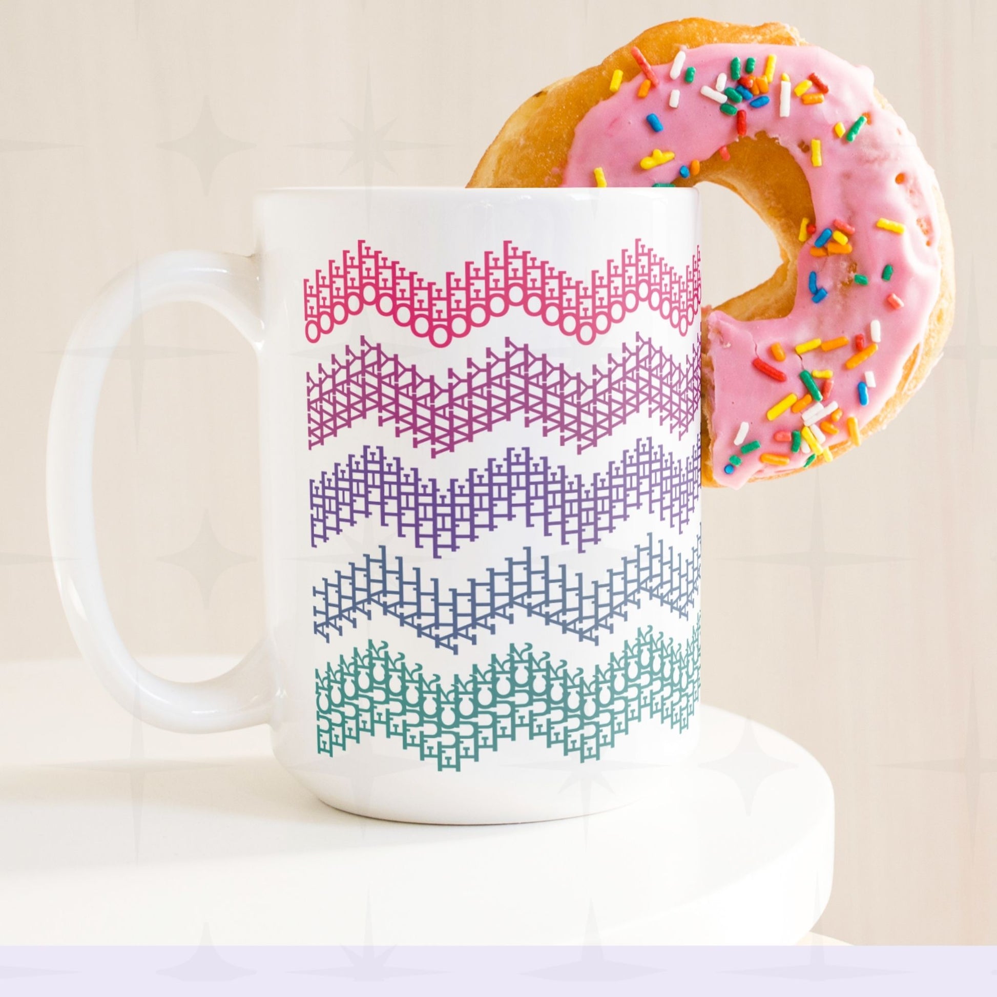 Bright stripes hidden profanity chevron mug in pink purple teal with a pink frosted donut balanced on the handle, retro styling