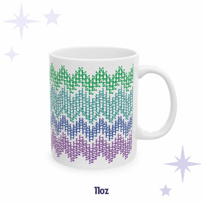 White ceramic 11oz hidden profanity mug with bright colorful fair isle zigzag pattern, straight-on product view on lavender star background
