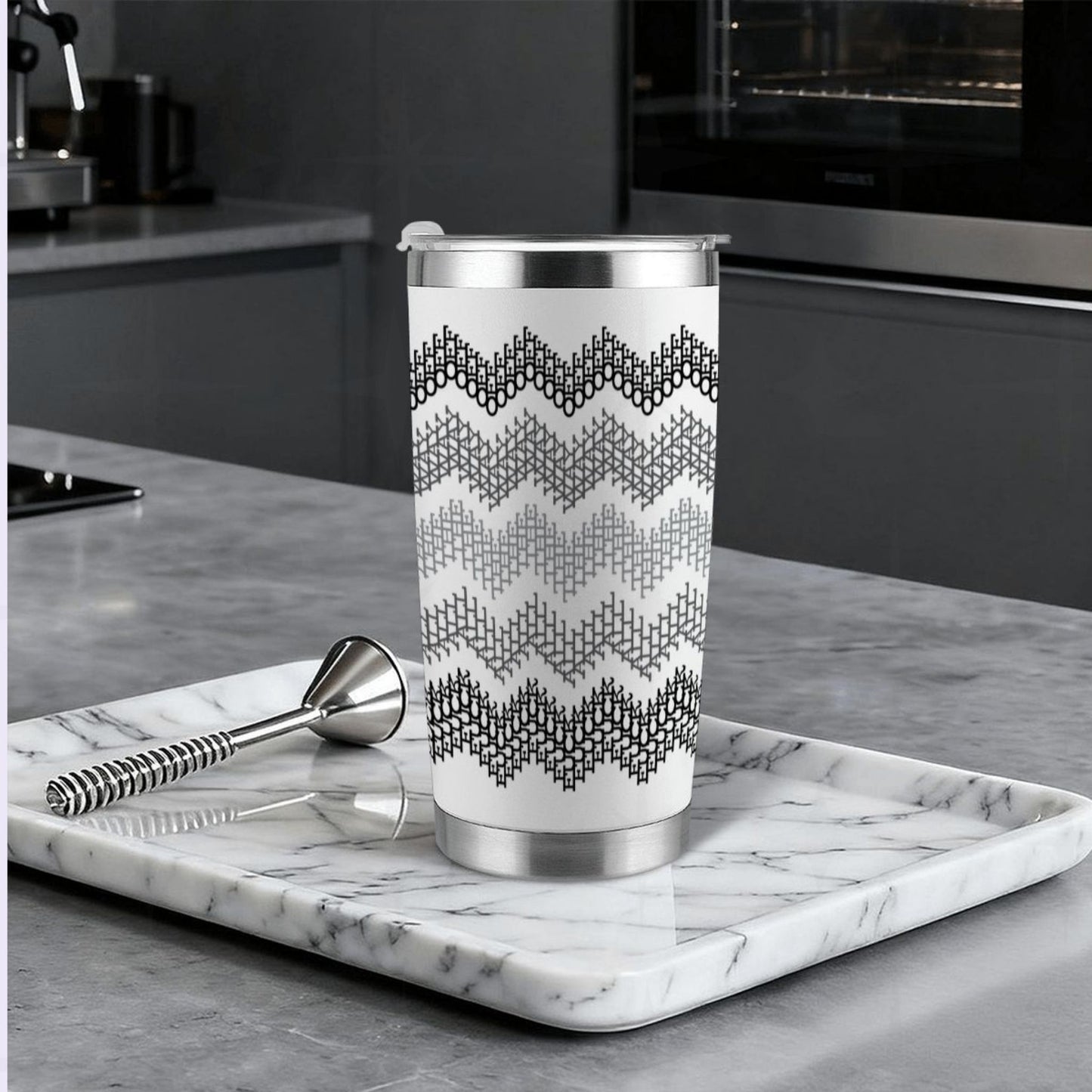 Gray stripe hidden profanity tumbler on marble tray in modern kitchen with cocktail bar spoon and stainless steel straw