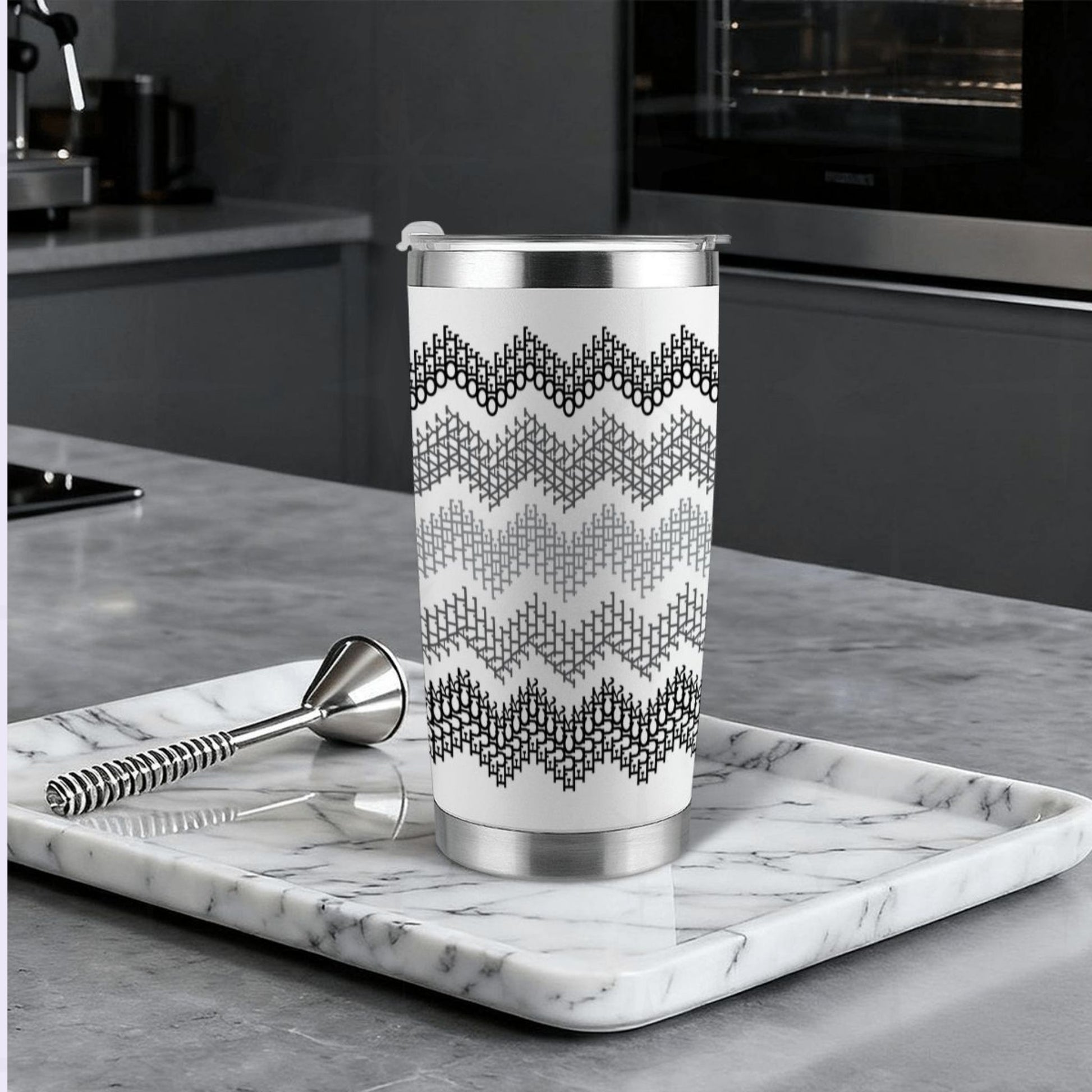 Gray stripe hidden profanity tumbler on marble tray in modern kitchen with cocktail bar spoon and stainless steel straw