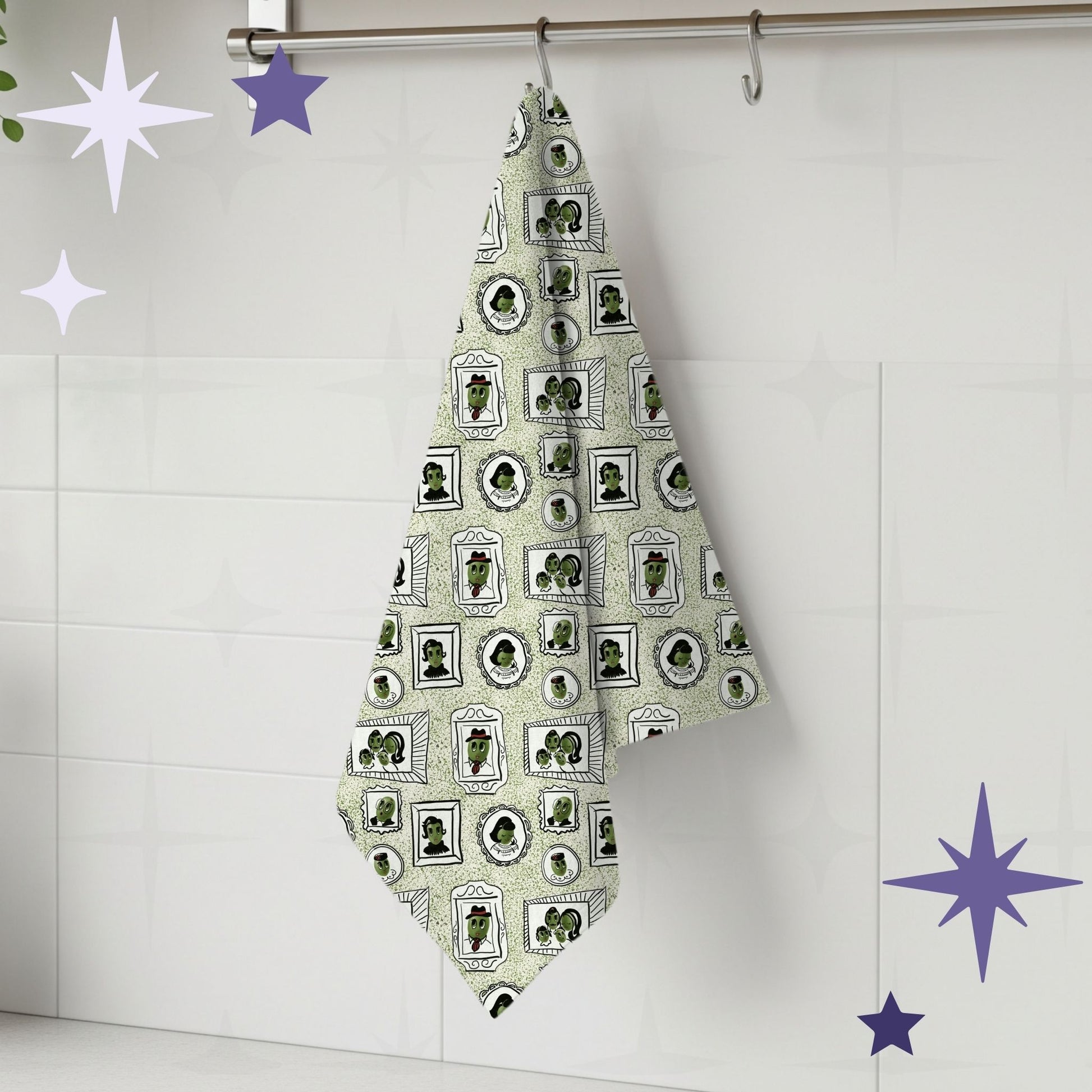 Sage green retro olive portrait tea towel hanging from silver kitchen hook against white tile backsplash