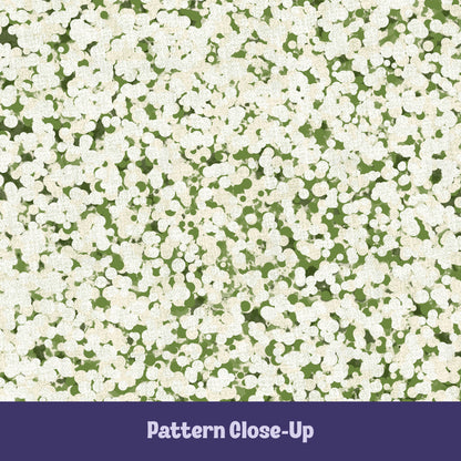 Close-up of sage green terrazzo pattern showing off-white pebble cluster shapes on olive green cotton twill ground