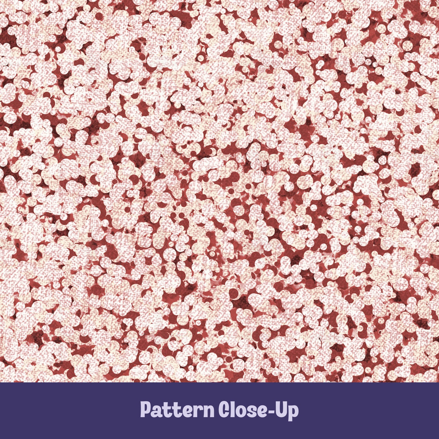 Close-up of terracotta red terrazzo pattern showing rounded cream pebble cluster shapes on brick red cotton twill ground