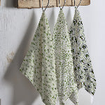 thumbnail Three Olive My Friends Are Weird tea towels hanging from rustic wooden hooks, featuring coordinating retro patterns in sage green including atomic starbursts, speckled texture, and illustrated olive character portrait frames