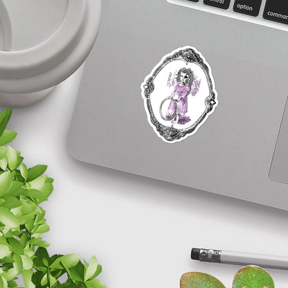Victorian gothic sticker applied to the corner of a silver laptop beside a mug and plant