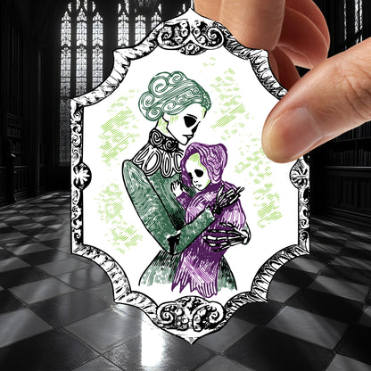 Victorian skeleton mother and baby sticker held between fingers above a black and white checkered stone floor