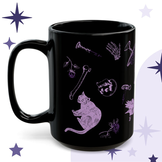 Witchcore mug in black ceramic with lilac engraving-style illustration of a black cat, loose bones, a skull, and a rose